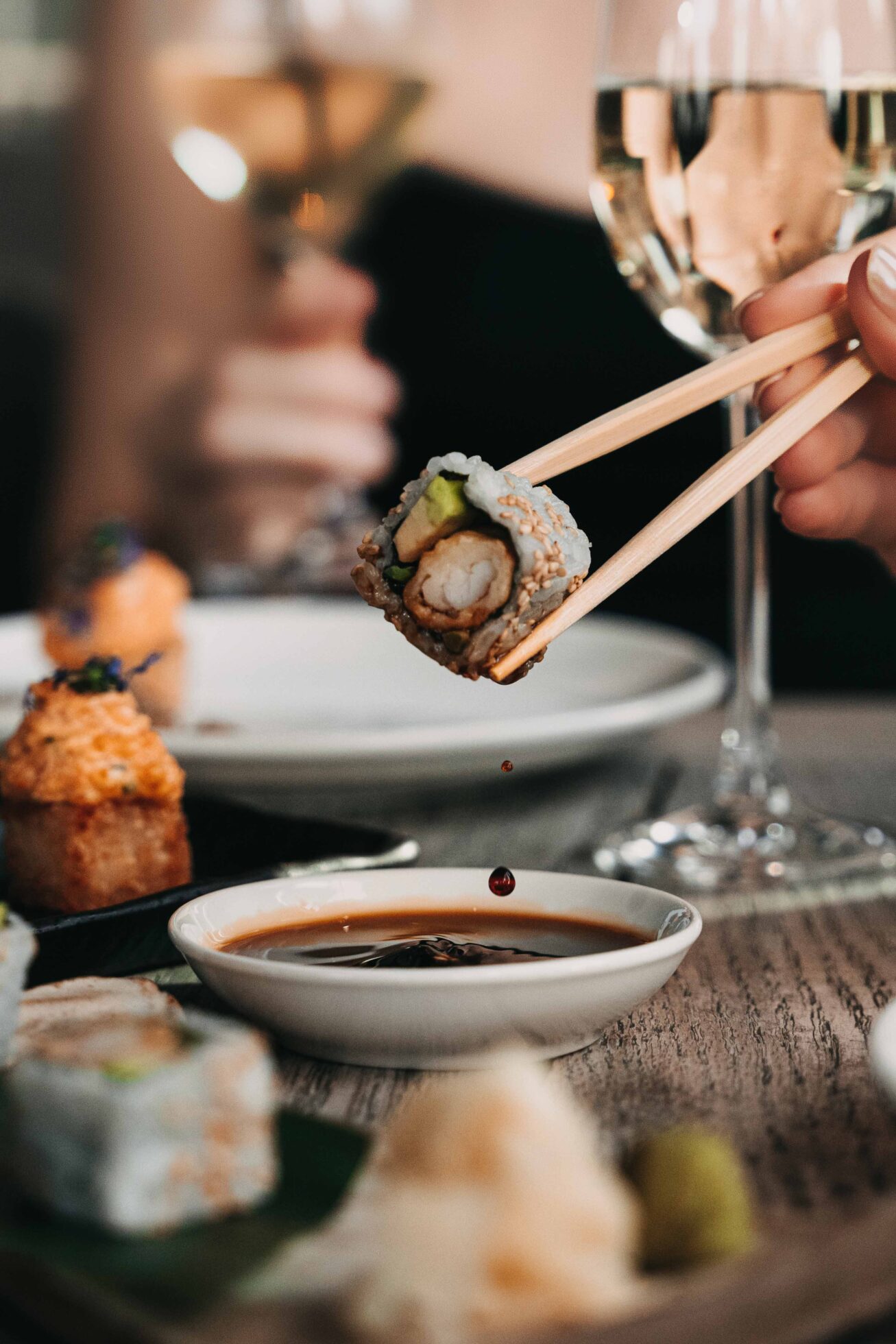 sushi being dipped in soya sauce at CLAP Dubai, a japanese fine dining restaurant