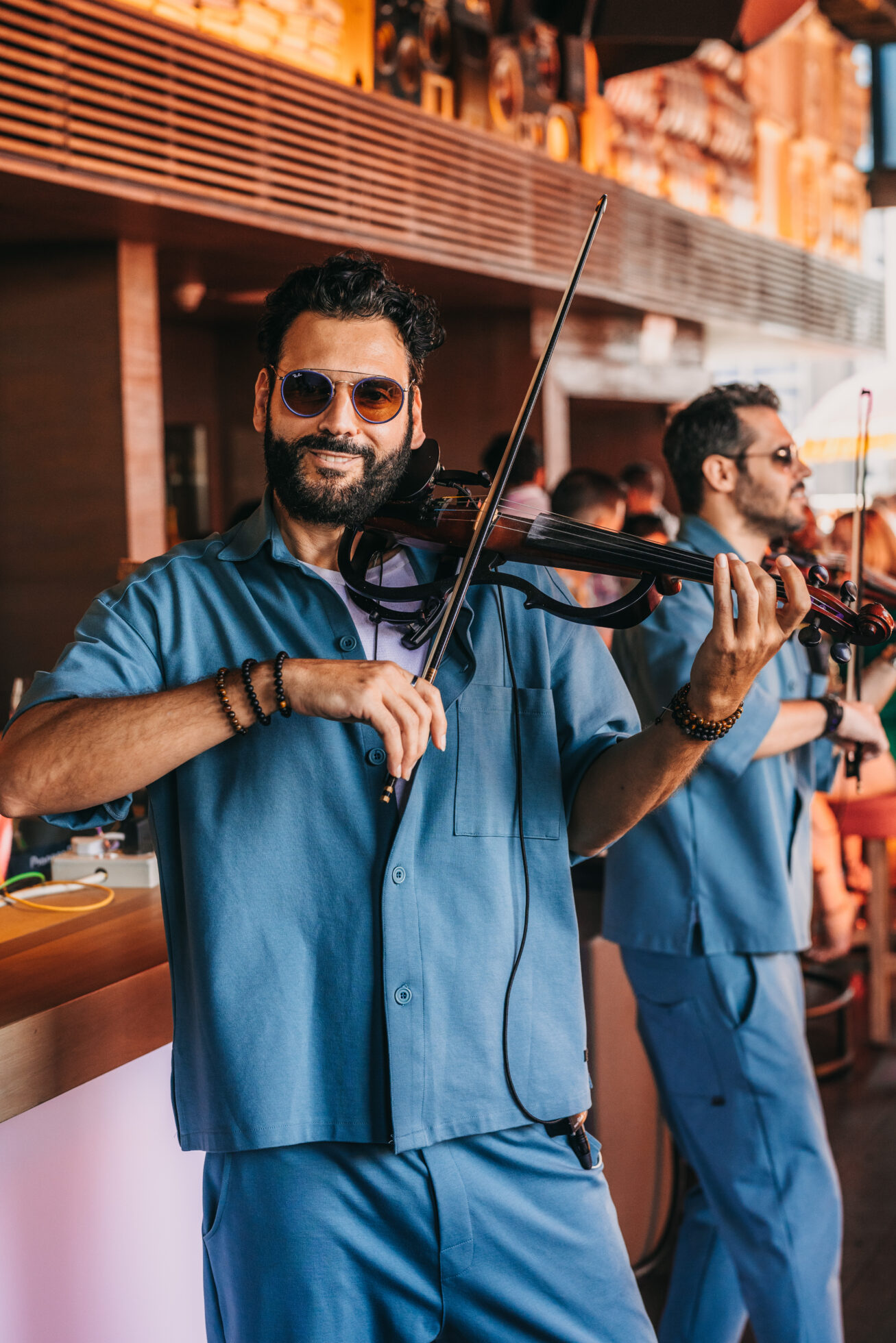 a few men playing voilin for CLAP DUBAI BURANCHI BRUNCH ENTERTAINMENT
