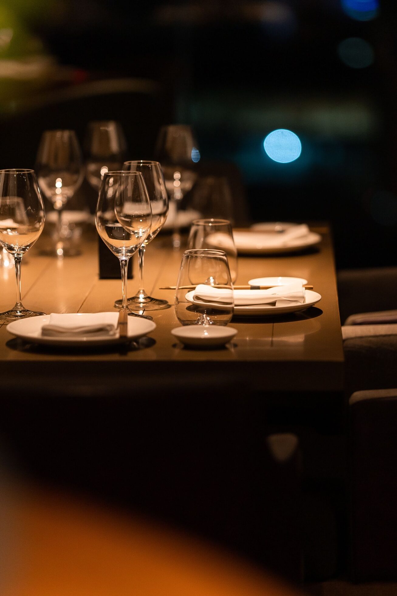 A set table with plates and wine glasses at CLAP London